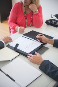 Senior couple and realtor discussing real estate contract at home office.